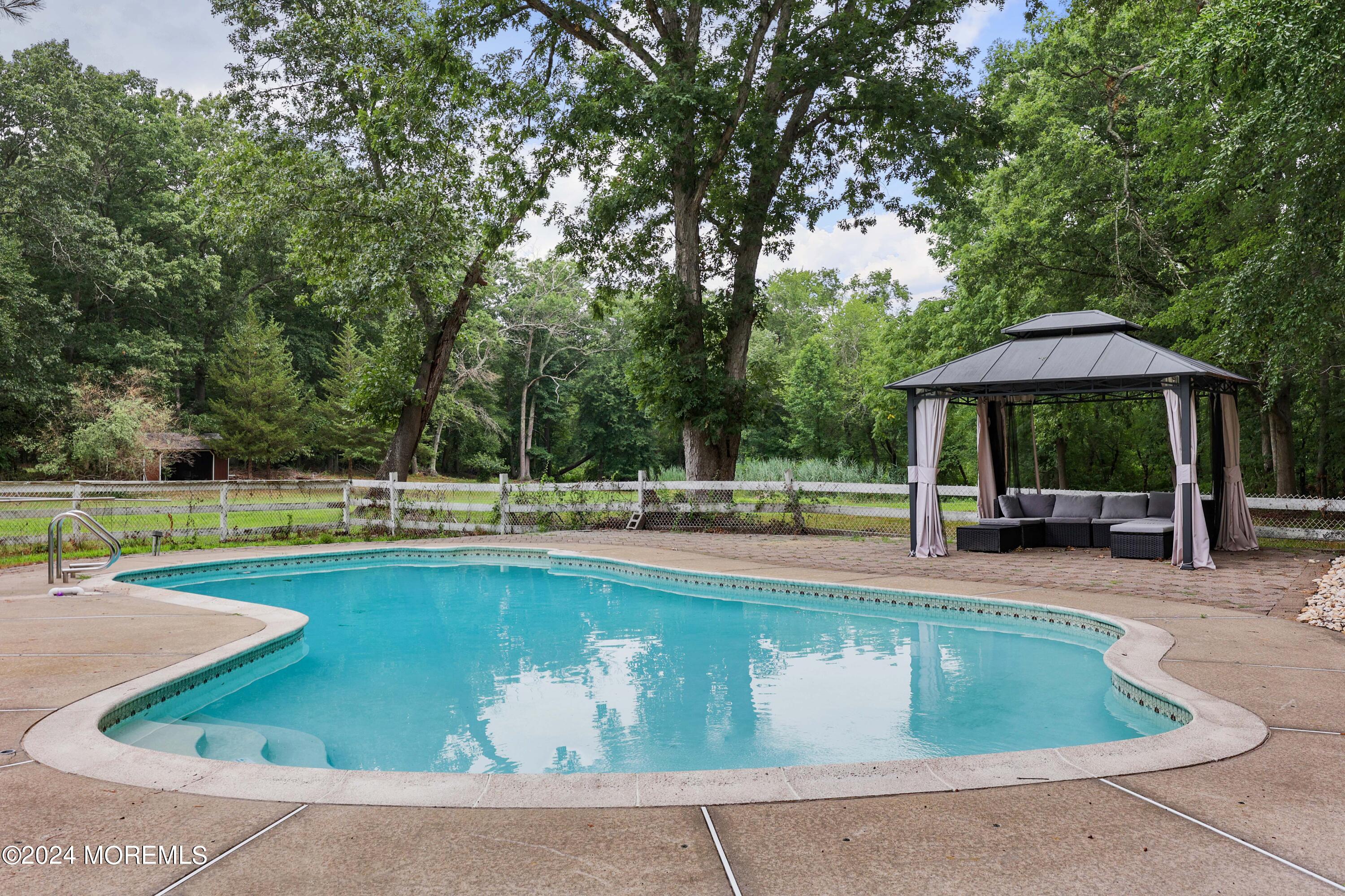 211 Georgia Road Freehold, NJ 07728 - Photo 33 of 41 a view of a swimming pool with sitting area