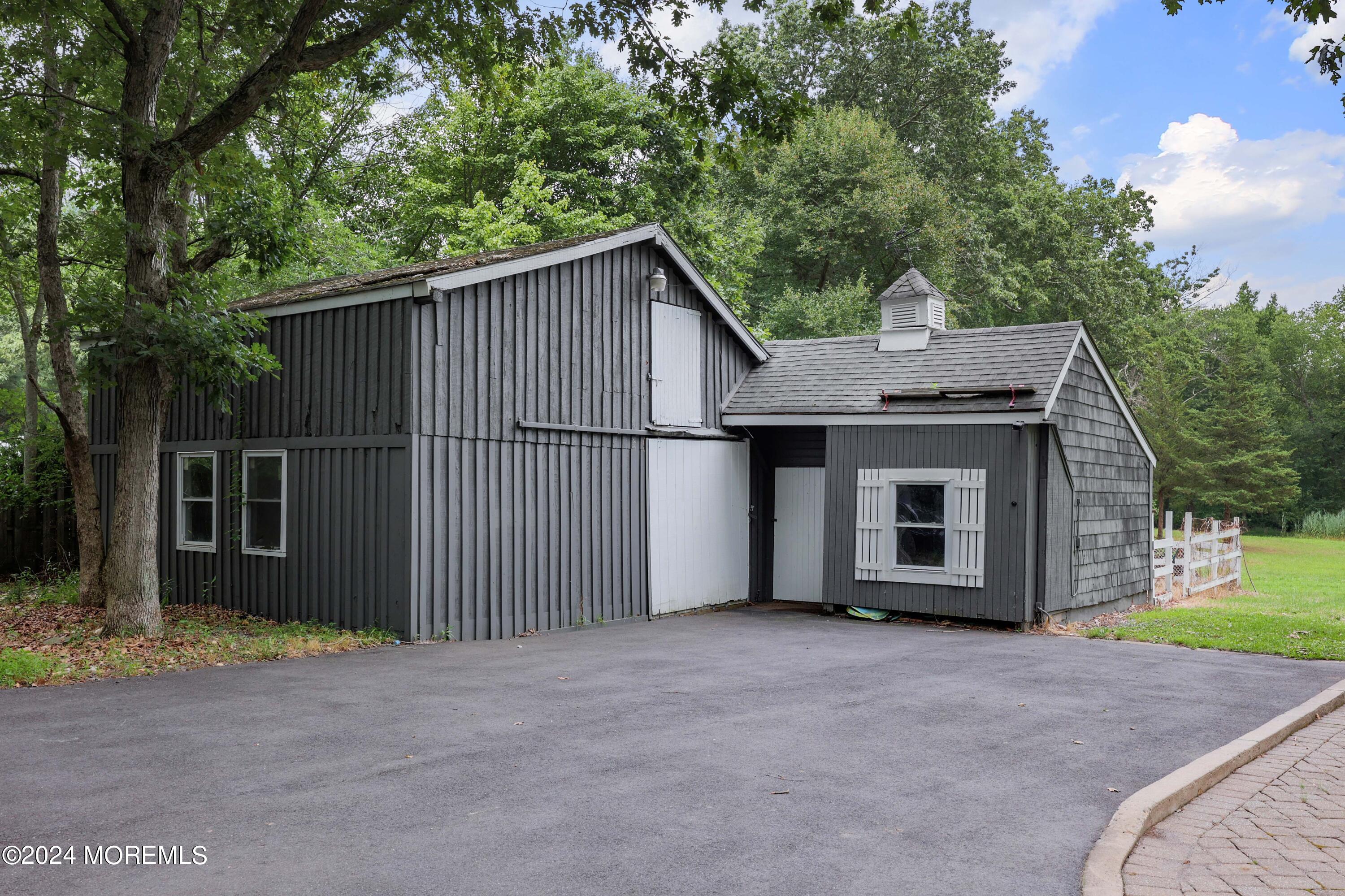 211 Georgia Road Freehold, NJ 07728 - Photo 38 of 41 a view of a house with a garage and yard