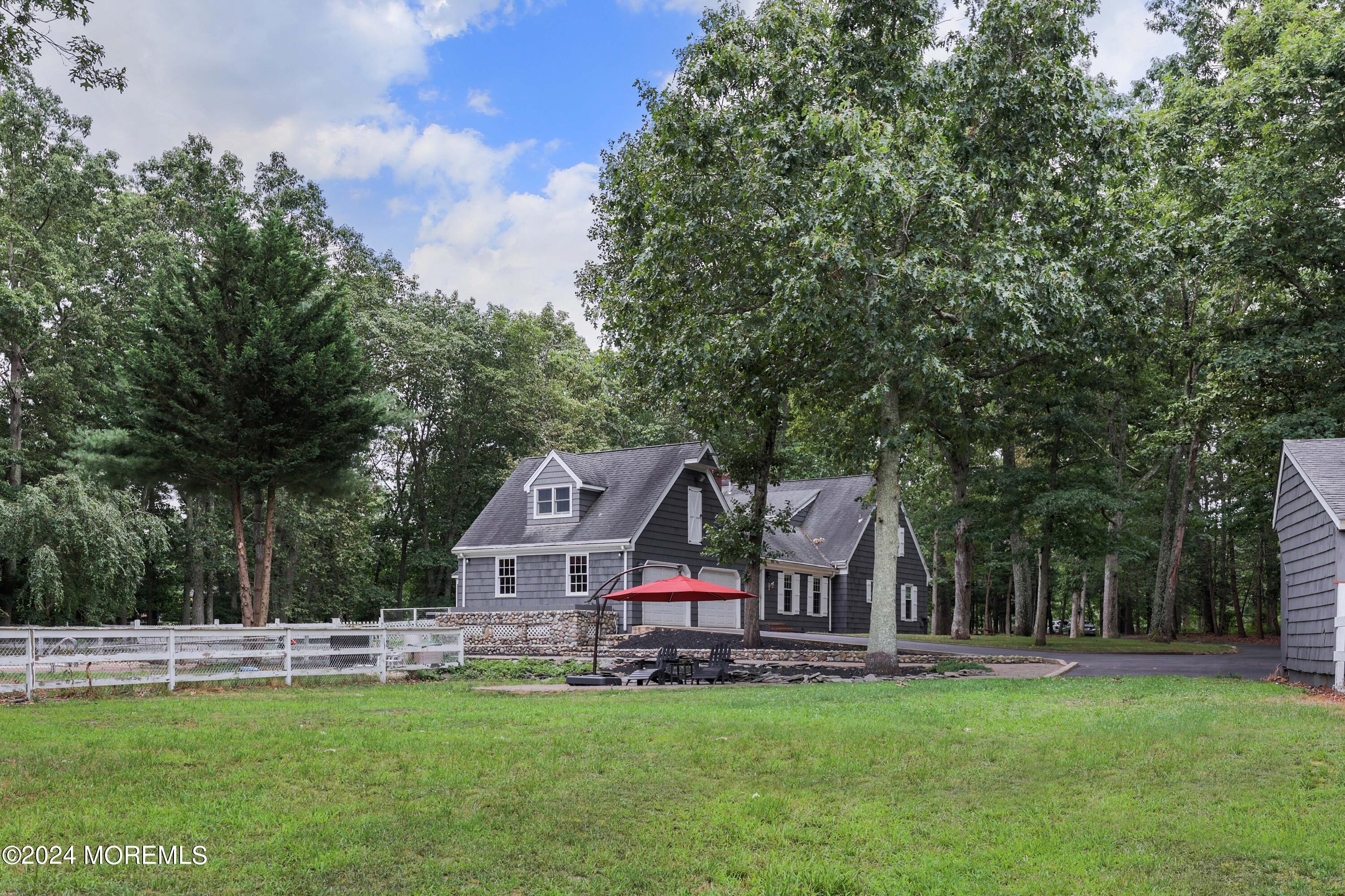 211 Georgia Road Freehold, NJ 07728 - Photo 8 of 41 a white house with a big yard and large trees
