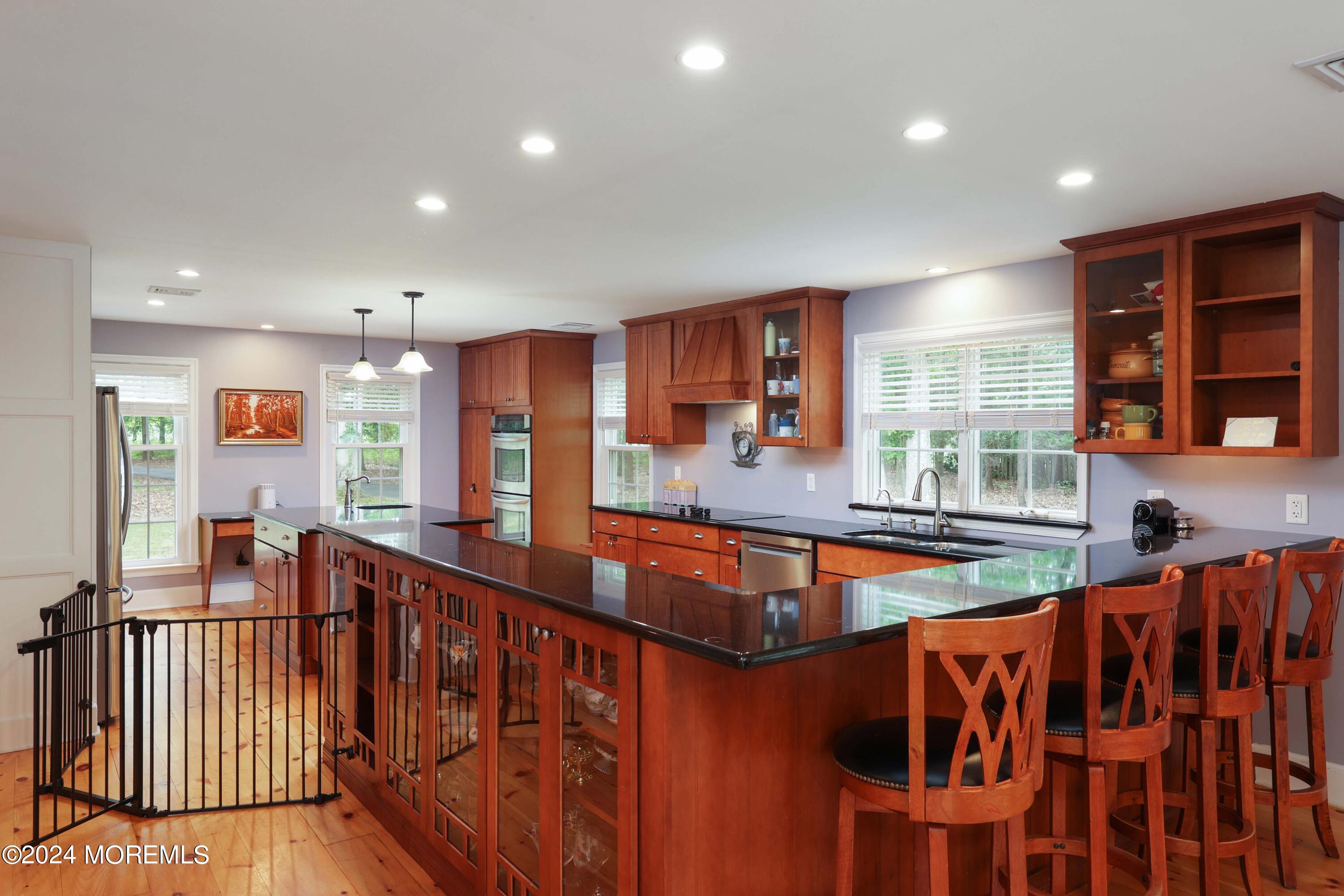 211 Georgia Road Freehold, NJ 07728 - Photo 10 of 41 a dining hall with stainless steel appliances granite countertop a stove and a sink
