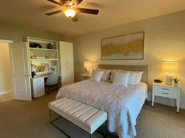 a bedroom with a bed and a chandelier