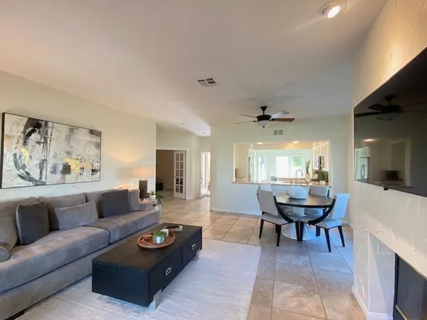 a living room with furniture and a fireplace