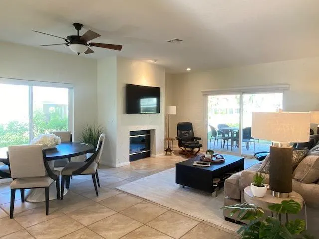 a living room with furniture a fireplace and a flat screen tv