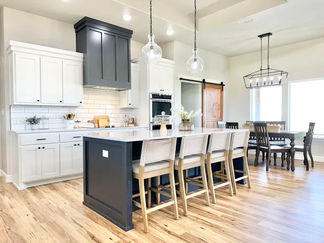 a kitchen with stainless steel appliances a refrigerator sink and cabinets