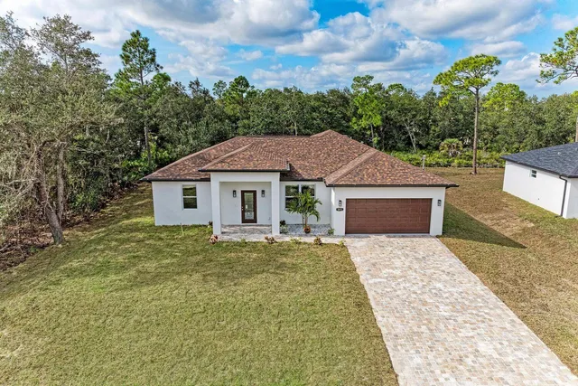 a aerial view of a house with yard patio and backyard