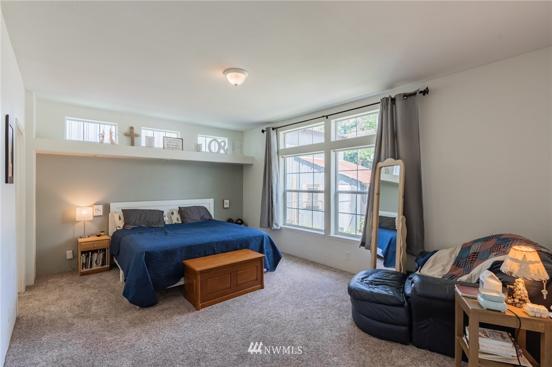 2065 East Pole Road Everson, WA 98247 - Photo 22 of 40 a bedroom with bed and a couch