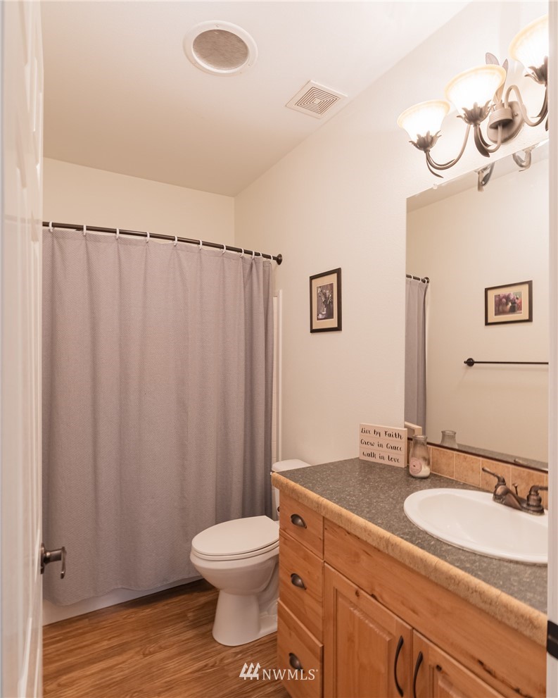 2065 East Pole Road Everson, WA 98247 - Photo 31 of 40 a bathroom with a granite countertop sink toilet and shower