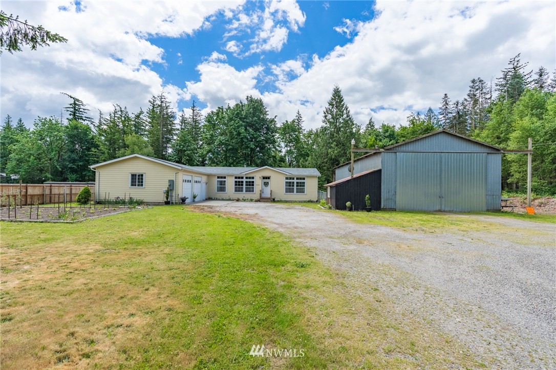 2065 East Pole Road Everson, WA 98247 - Photo 7 of 40 a front view of a house with a yard and garage
