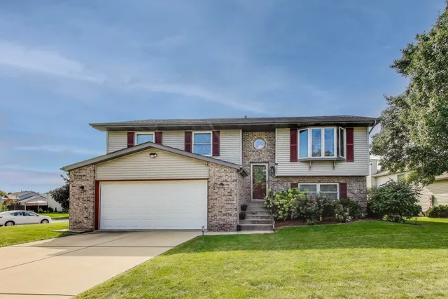 a front view of a house with a yard and garage