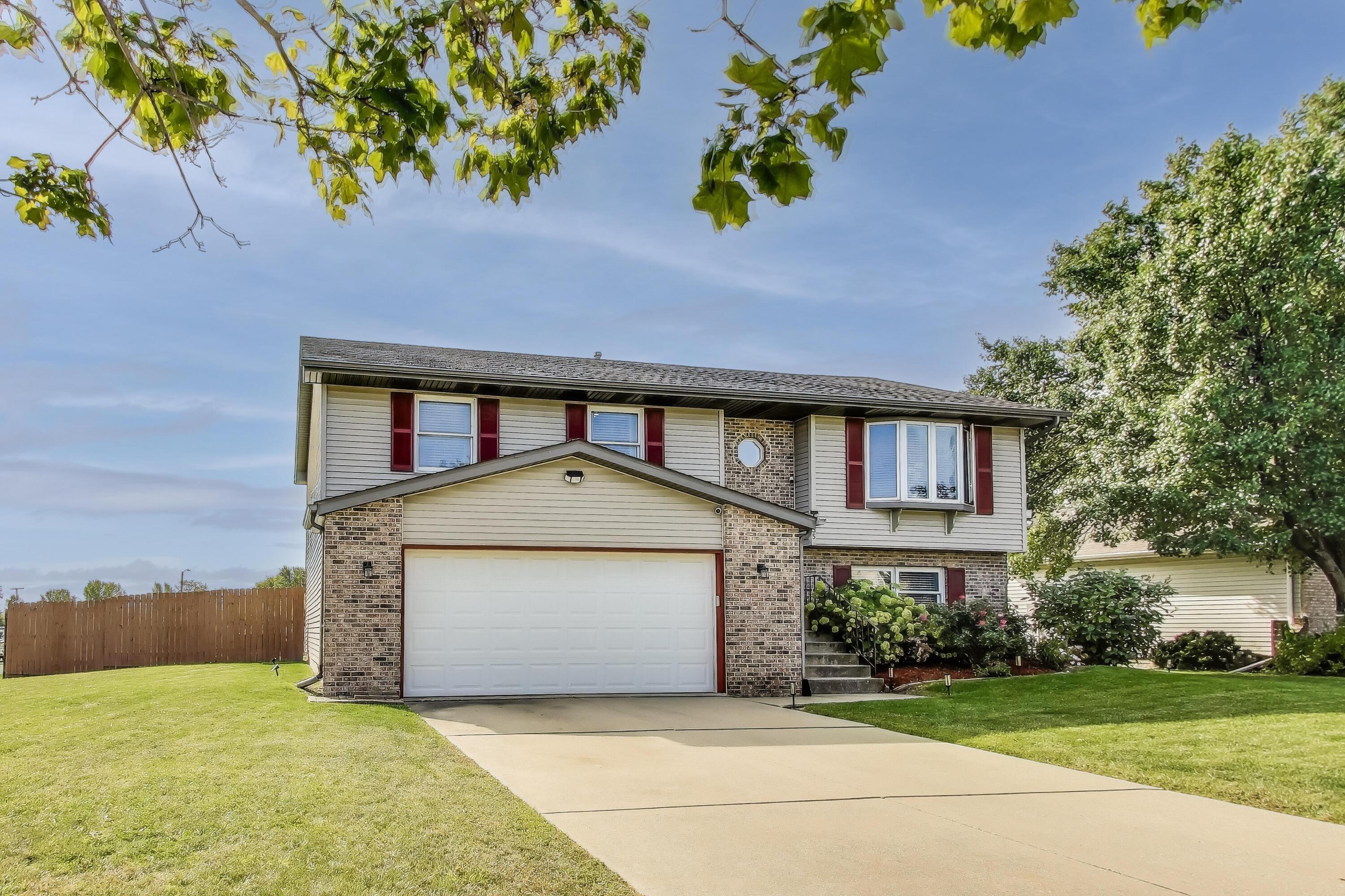 1235 West 99th Avenue Crown Point, IN 46307 - Photo 33 of 54 a front view of a house with a yard and garage