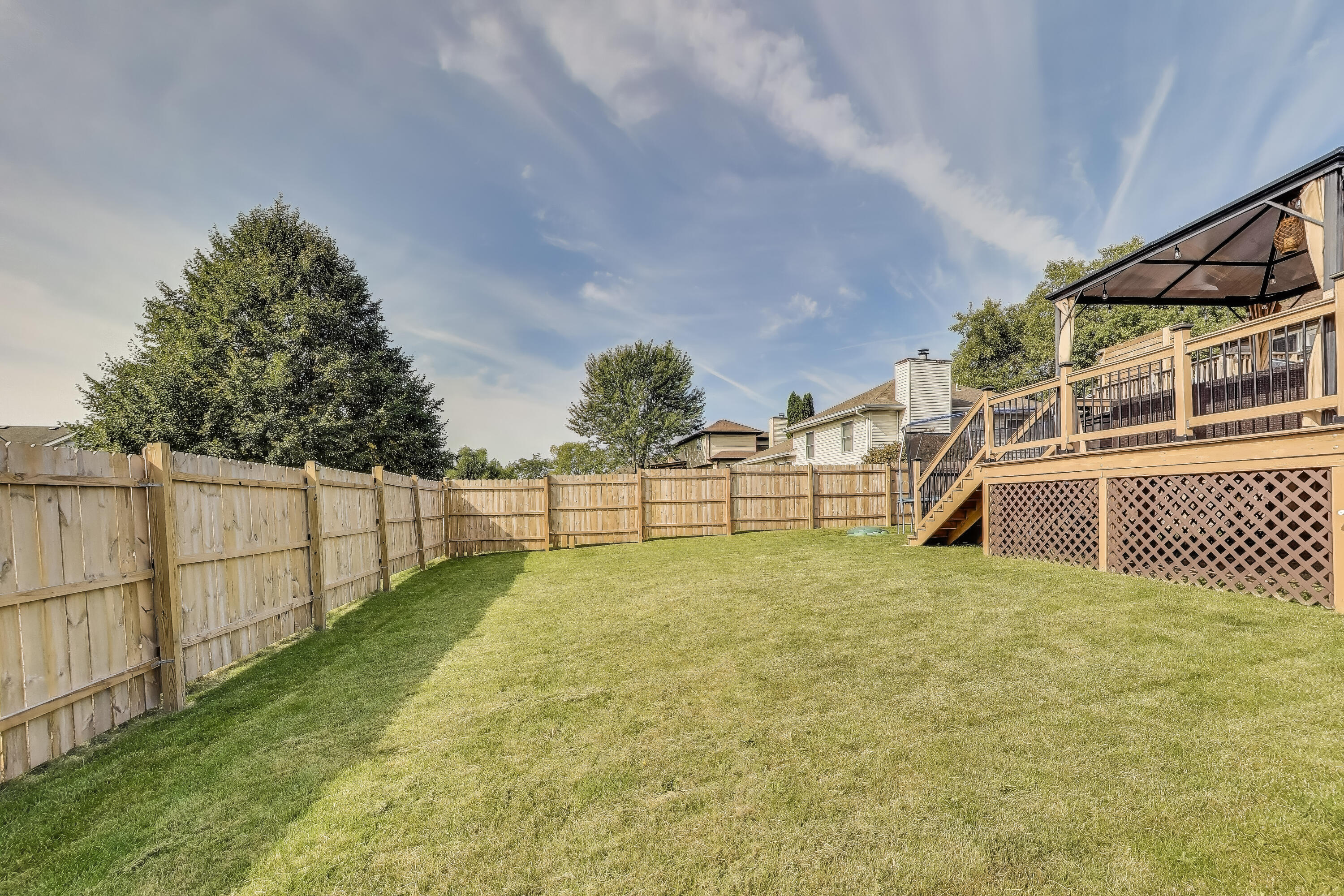 1235 West 99th Avenue Crown Point, IN 46307 - Photo 37 of 54 a view of a yard with wooden fence