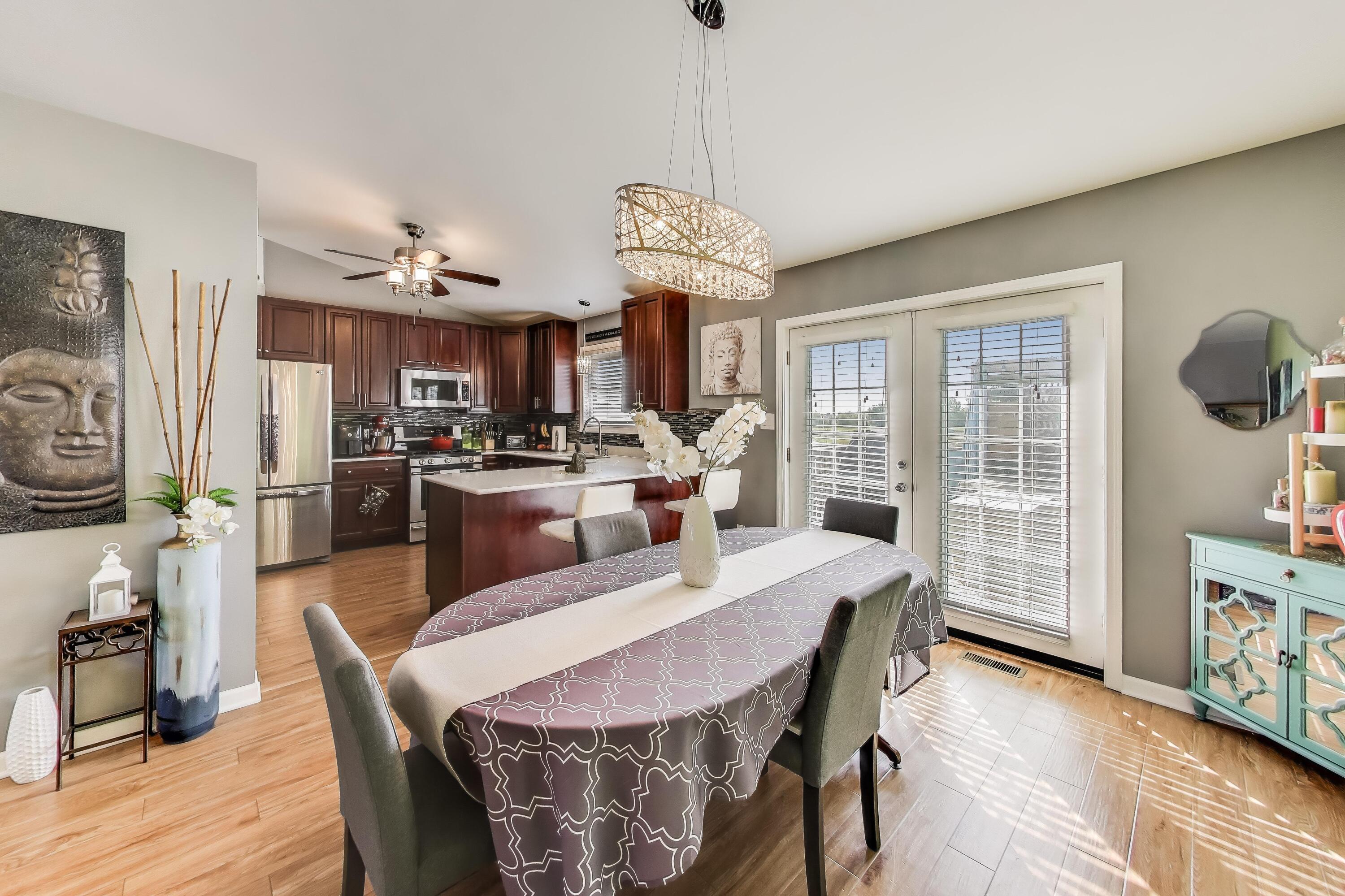 1235 West 99th Avenue Crown Point, IN 46307 - Photo 5 of 54 a view of a dining room with furniture large window and wooden floor