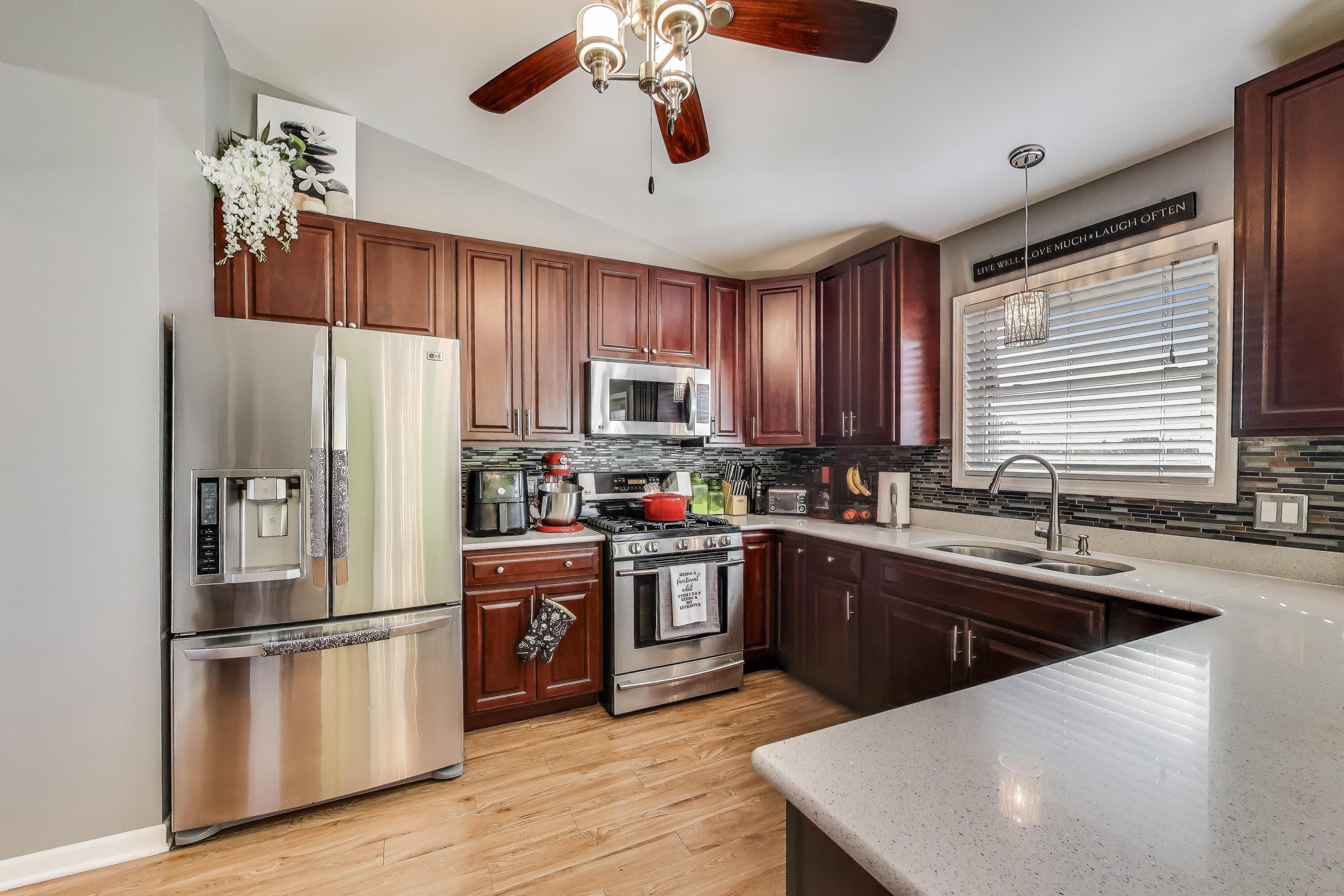 1235 West 99th Avenue Crown Point, IN 46307 - Photo 8 of 54 a kitchen with stainless steel appliances granite countertop a refrigerator a sink dishwasher a stove and a refrigerator