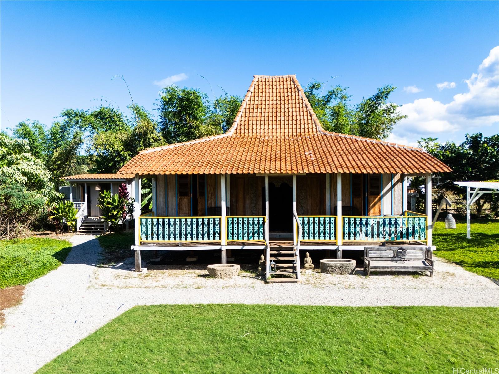 4 Kaukonahua Road Waialua, HI 96791 - Photo 7 of 25 a front view of a house with a garden and deck