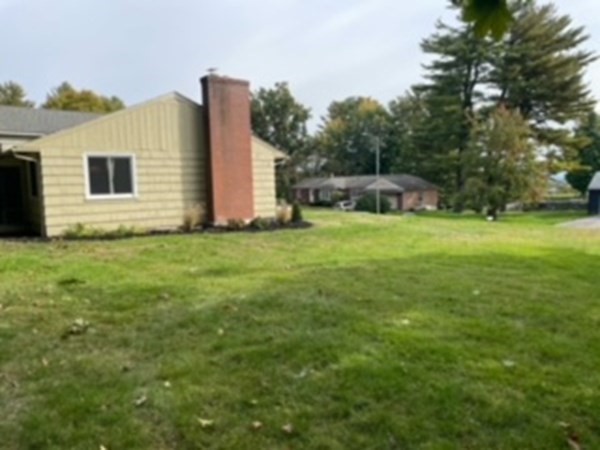 15 Steiger Road Holyoke, MA 01040 - Photo 28 of 29 a backyard of a house with plants and large tree