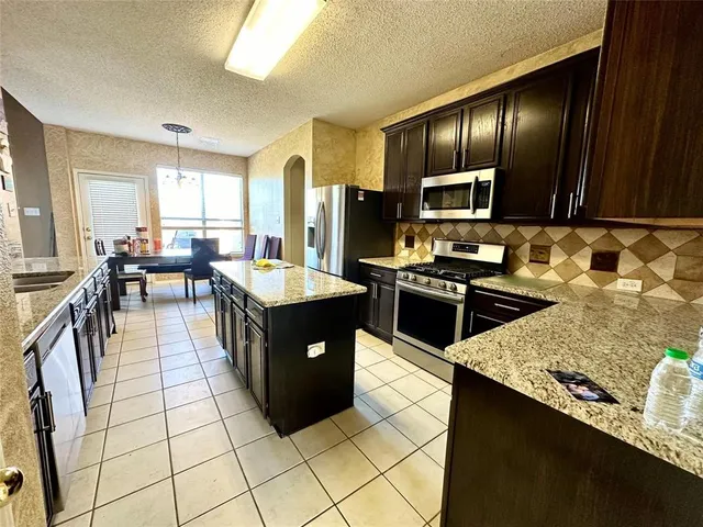 a large kitchen with lots of counter space and a sink