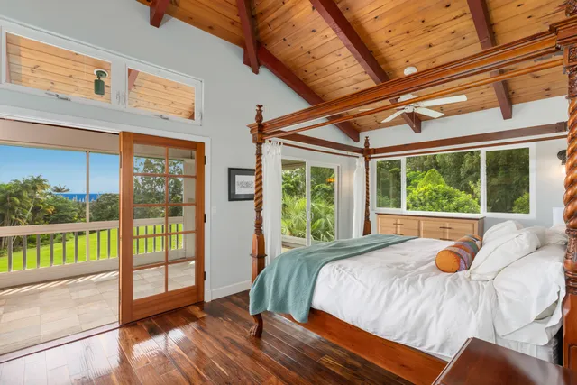 a spacious bedroom with a large bed and a large window