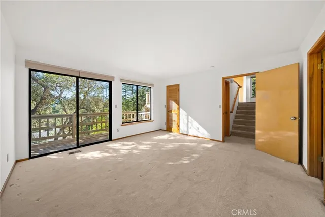 a view of an empty room with large windows