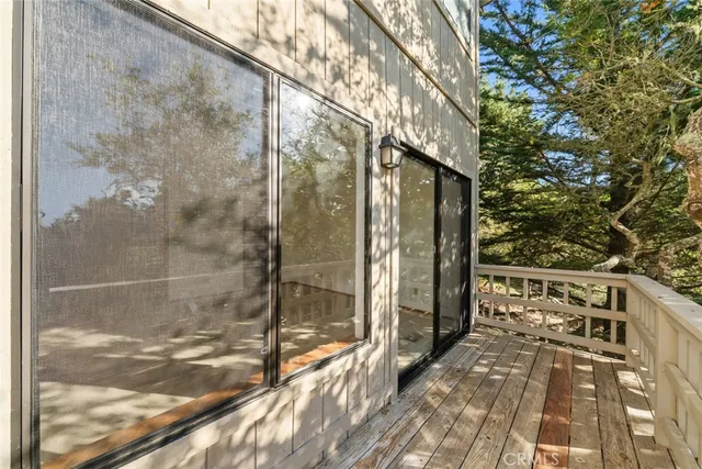 a view of a balcony with wooden fence and floor