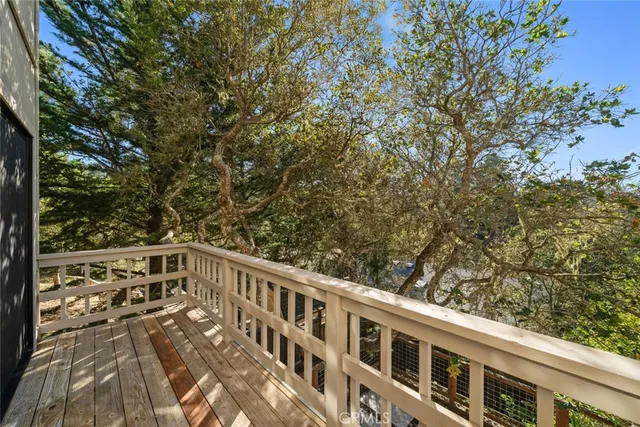 a view of balcony with wooden floor and fence