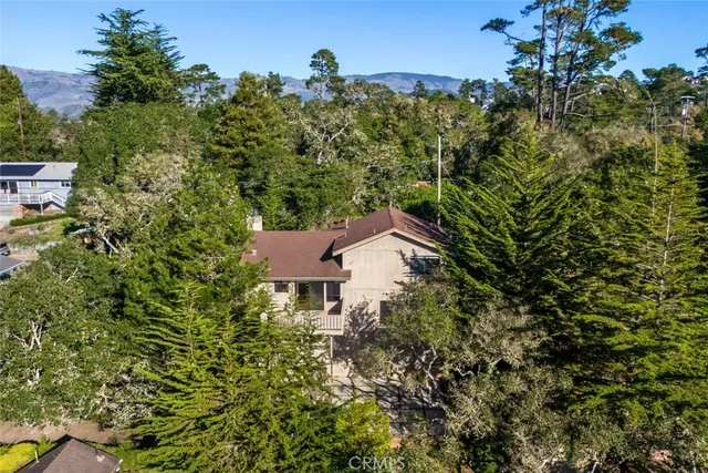 an aerial view of a house with a yard
