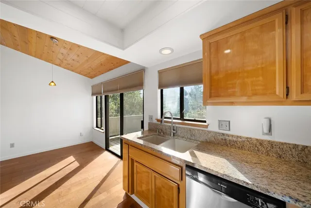 a kitchen with stainless steel appliances granite countertop a refrigerator and a sink