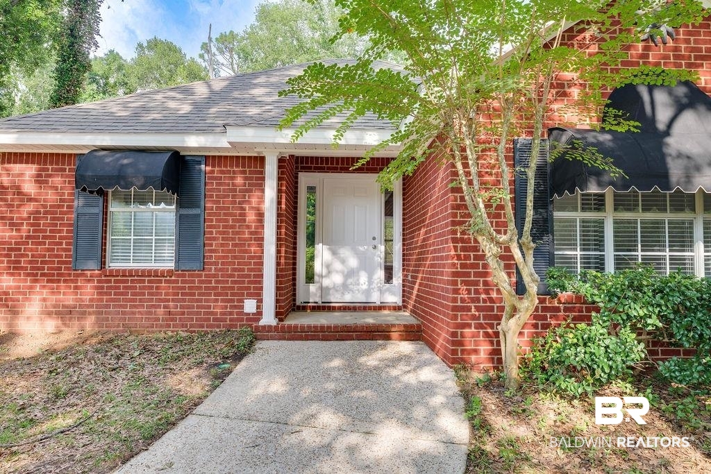 31246 Shambo Road Daphne, AL 36527 - Photo 21 of 26 Property entrance with brick siding and roof with shingles