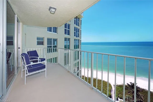 a living room with furniture and a lamp