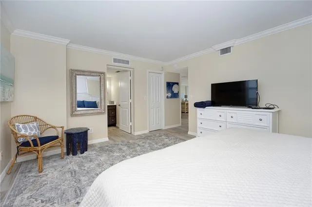 a bedroom with a bed and a television