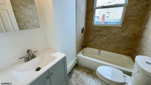 a bathroom with a sink a toilet and bathtub