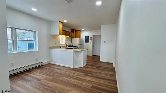 a kitchen with a refrigerator and window
