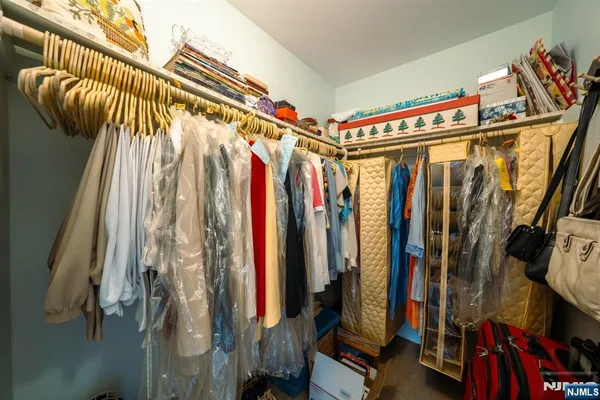 a view of walk in closet with clothes