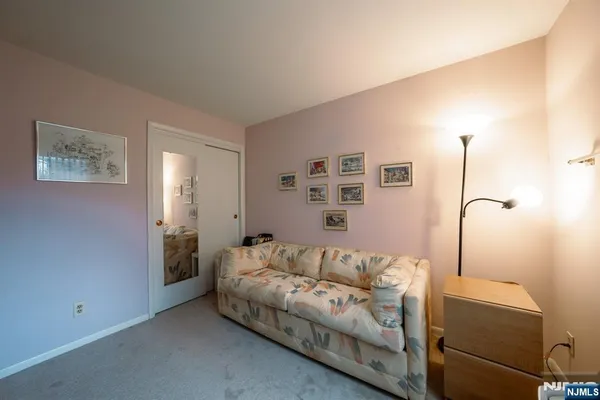 a living room with furniture and a lamp