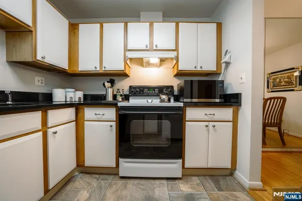a kitchen with granite countertop a stove a sink and a granite counter tops