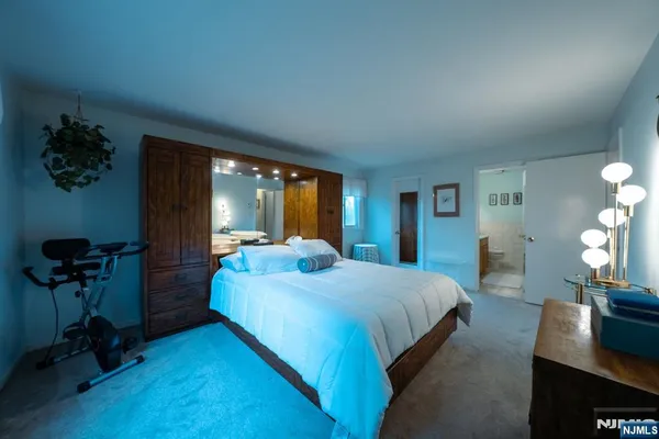 a bedroom with a bed and a potted plant