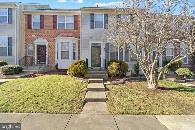 a view of a brick house with large windows