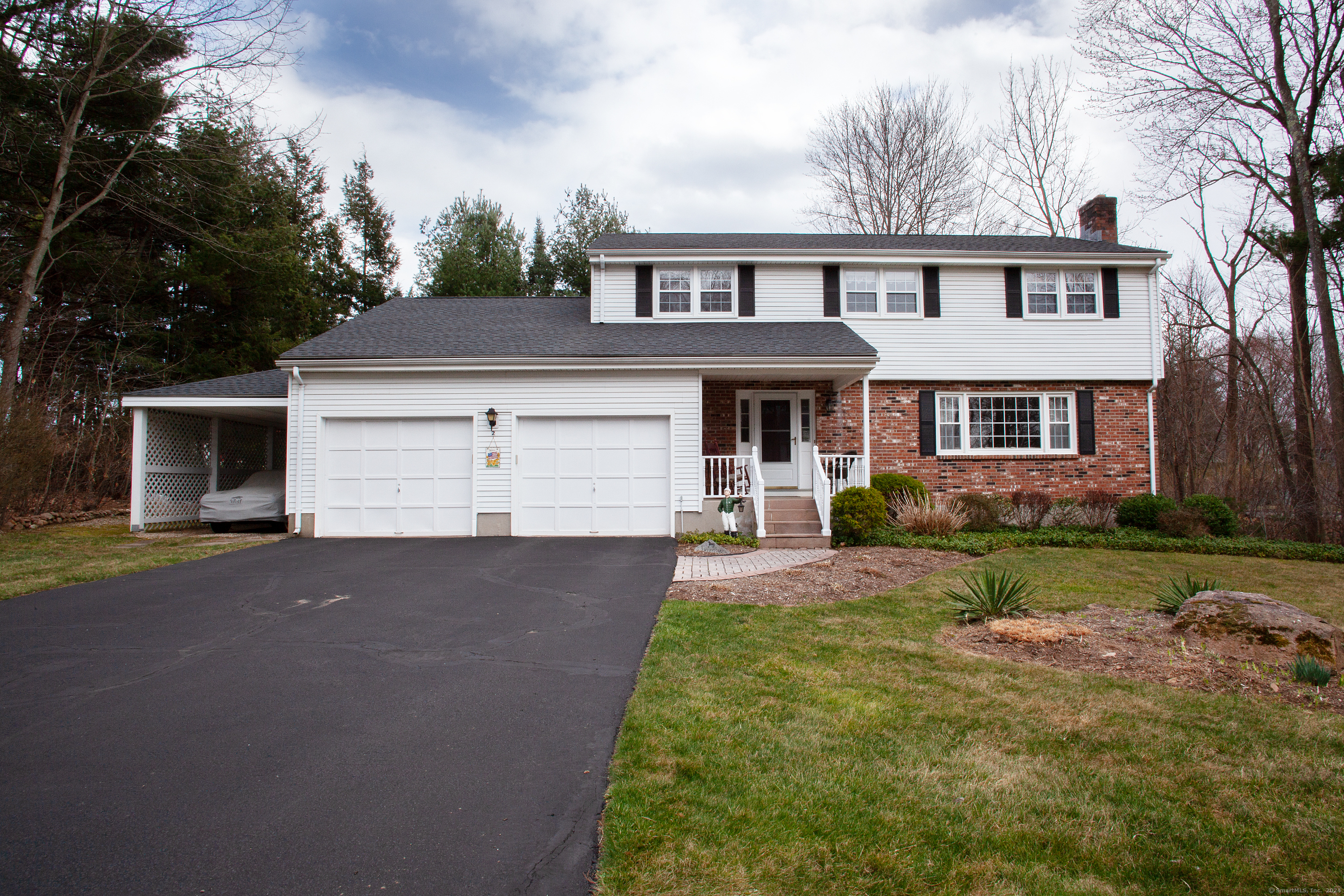 2 Fire Brick Lane Simsbury, CT 06070 - Photo 1 of 1 a front view of a house with a yard and garage