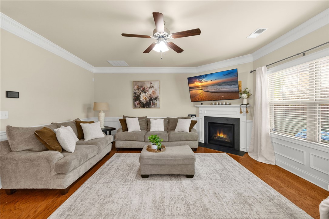 874 Wild Orchard Lane Woodruff, SC 29388 - Photo 5 of 35 This inviting living space features warm hardwood floors and a cozy fireplace.