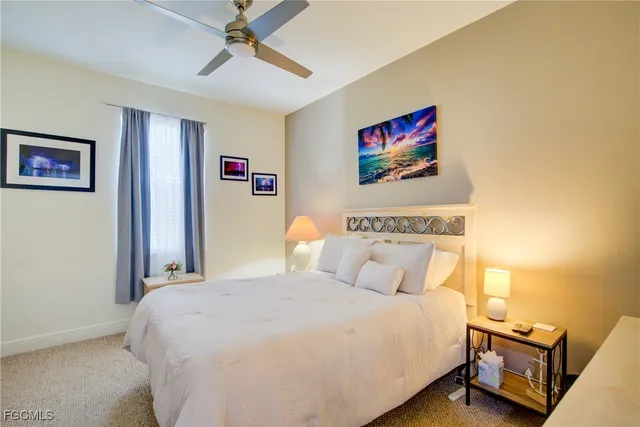 a bedroom with a bed and a wall painting