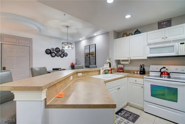 a kitchen with a sink a stove and cabinets
