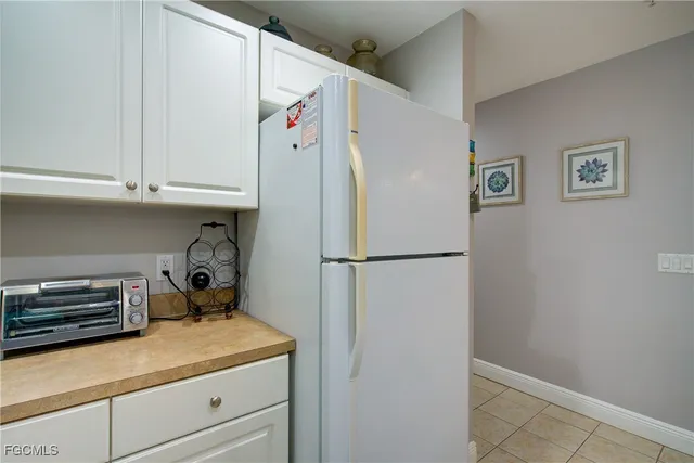 a white refrigerator freezer sitting in a kitchen
