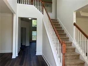 a view of a hallway with wooden floor and entryway