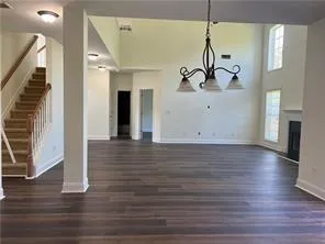 a view of a room with wooden floor and stairs