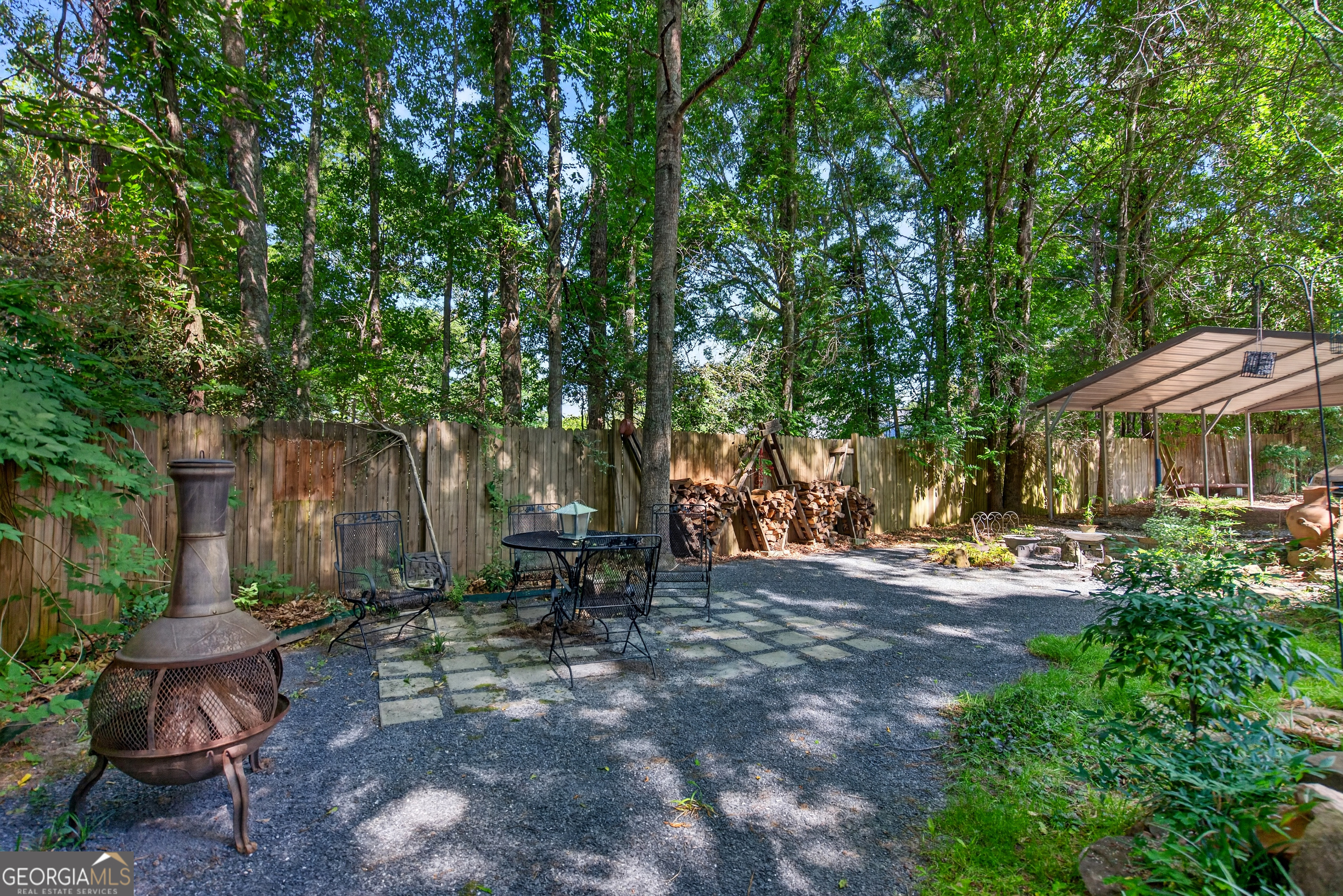 4656 Greenville Road LaGrange, GA 30241 - Photo 31 of 34 a view of a patio with table and chairs under an umbrella