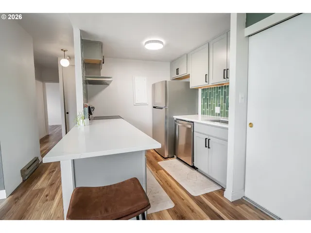 a kitchen with stainless steel appliances a refrigerator and a stove