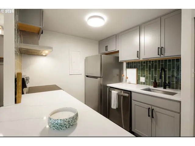 a kitchen with a sink and refrigerator