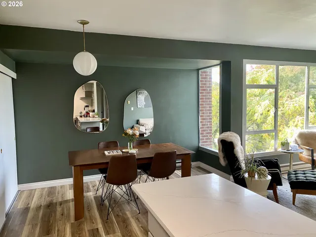 a view of a dining room with furniture and a large window