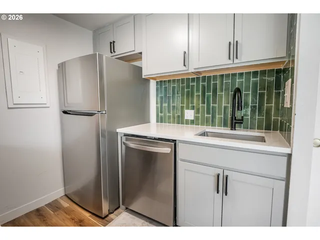 a kitchen with a refrigerator and a sink