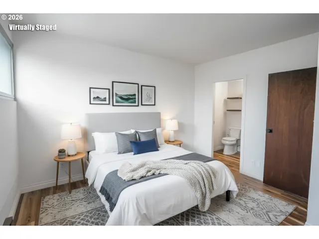 a bedroom with a bed and a painting on the wall