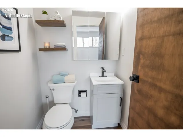 a bathroom with a toilet sink and mirror